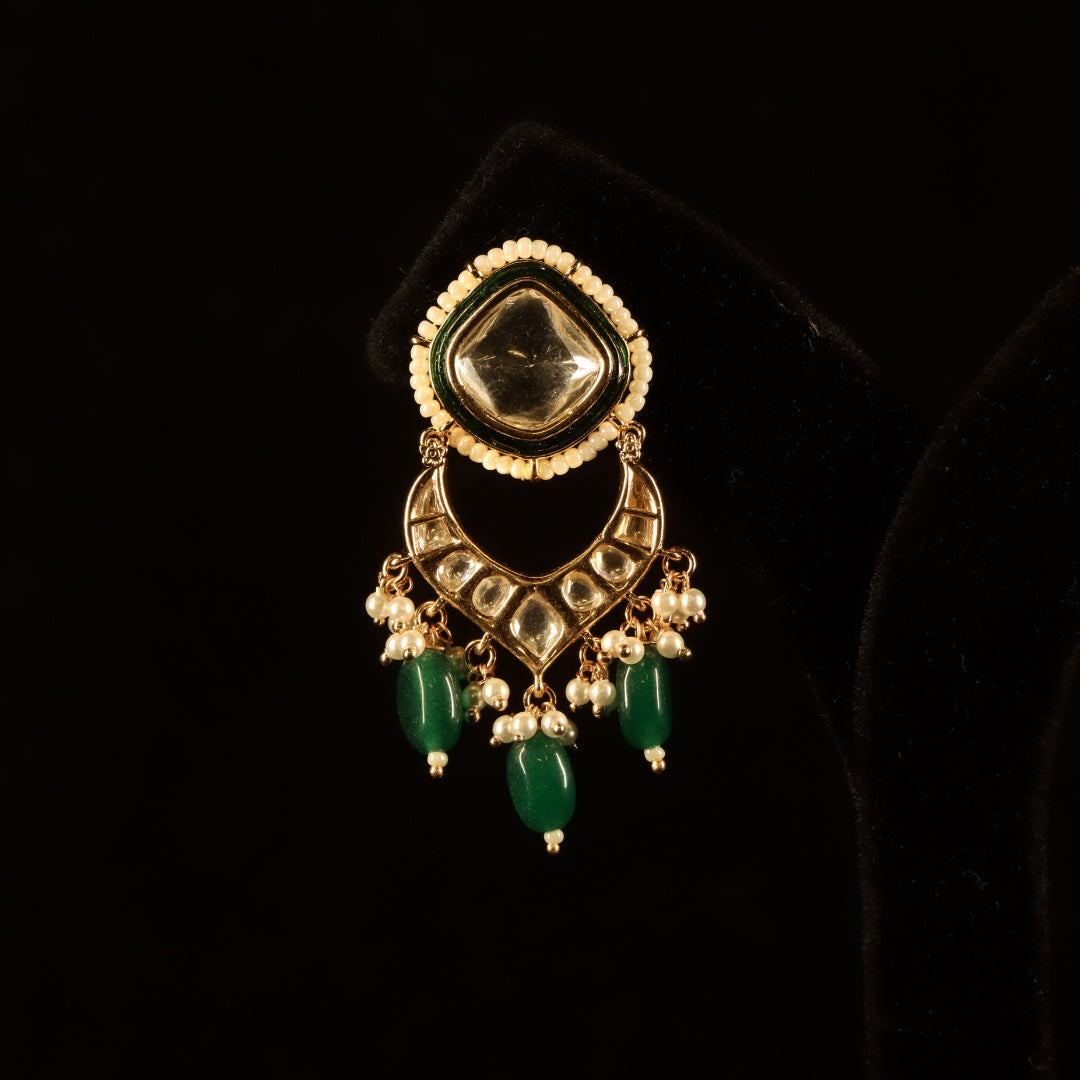 kundan earrings with green emerald stone accents and intricate craftsmanship