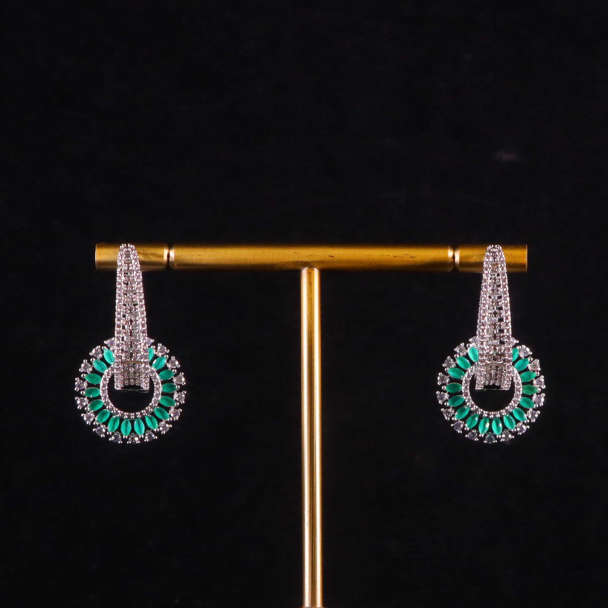 silver diamond earrings with emerald accents