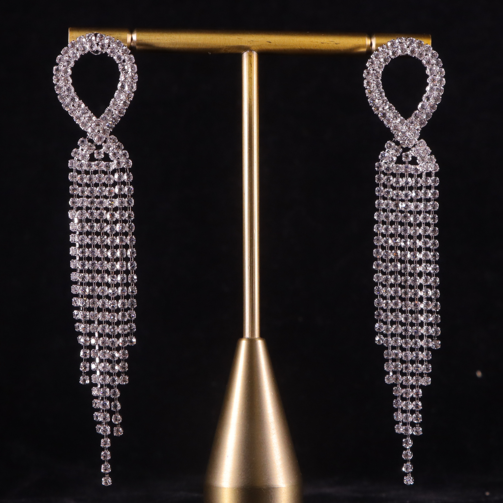 elegant party earrings that feature a series of sparkling diamond tiers cascading elegantly from the ear