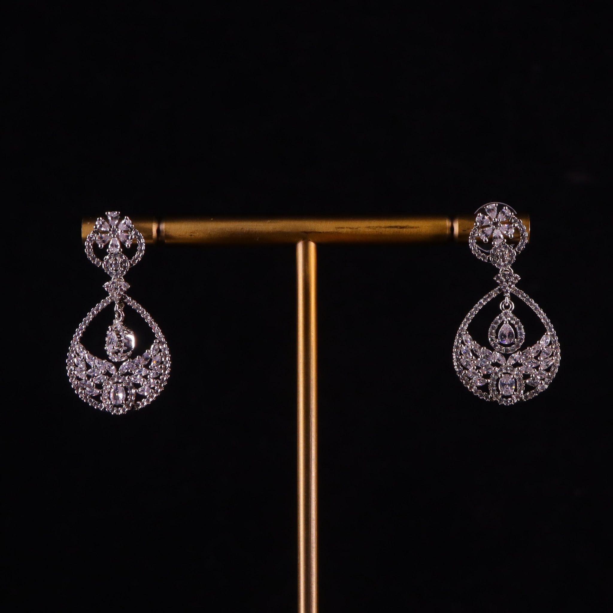 silver diamond earrings with intricate designs