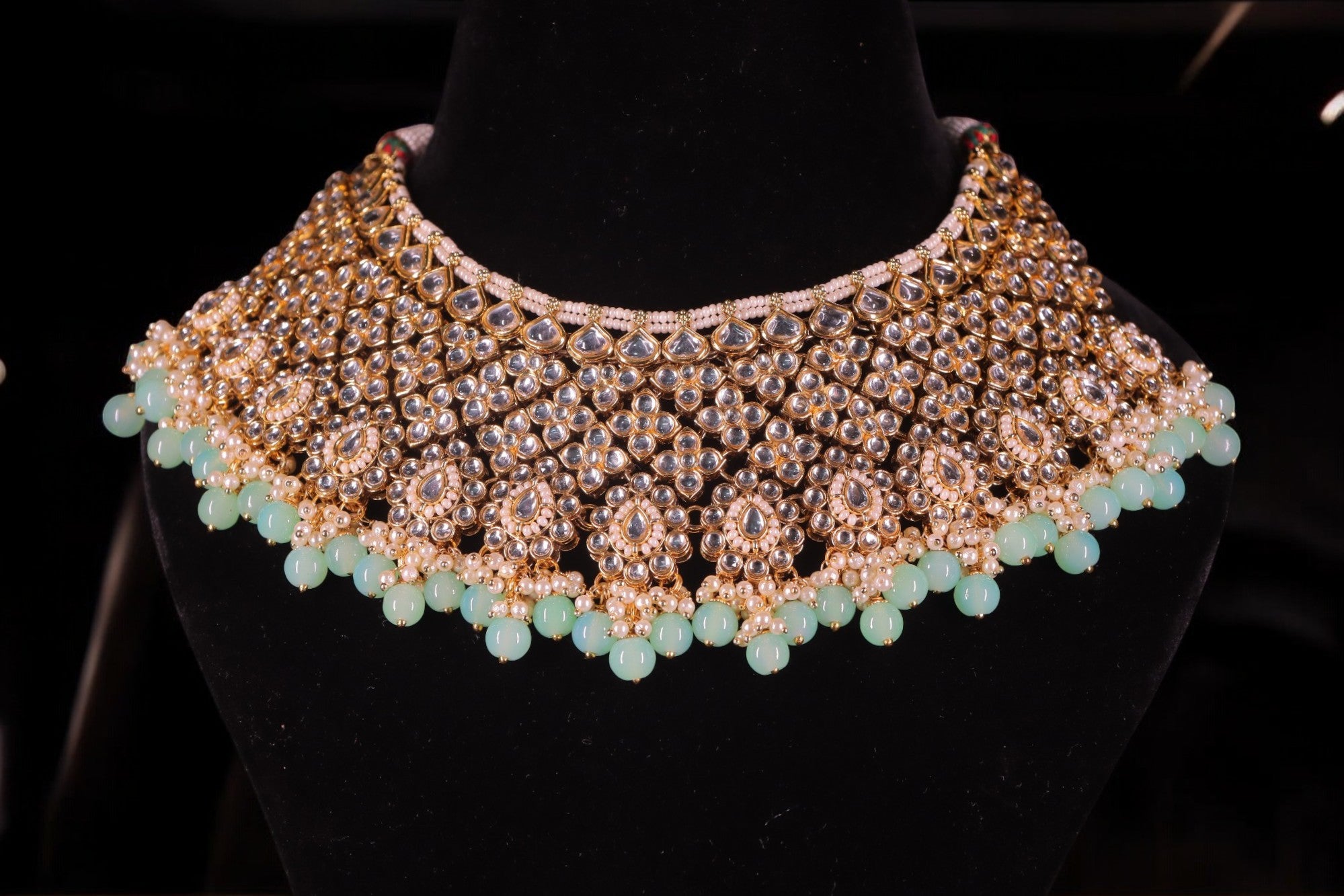 A soft blue and gold-colored Kundan jewelry set