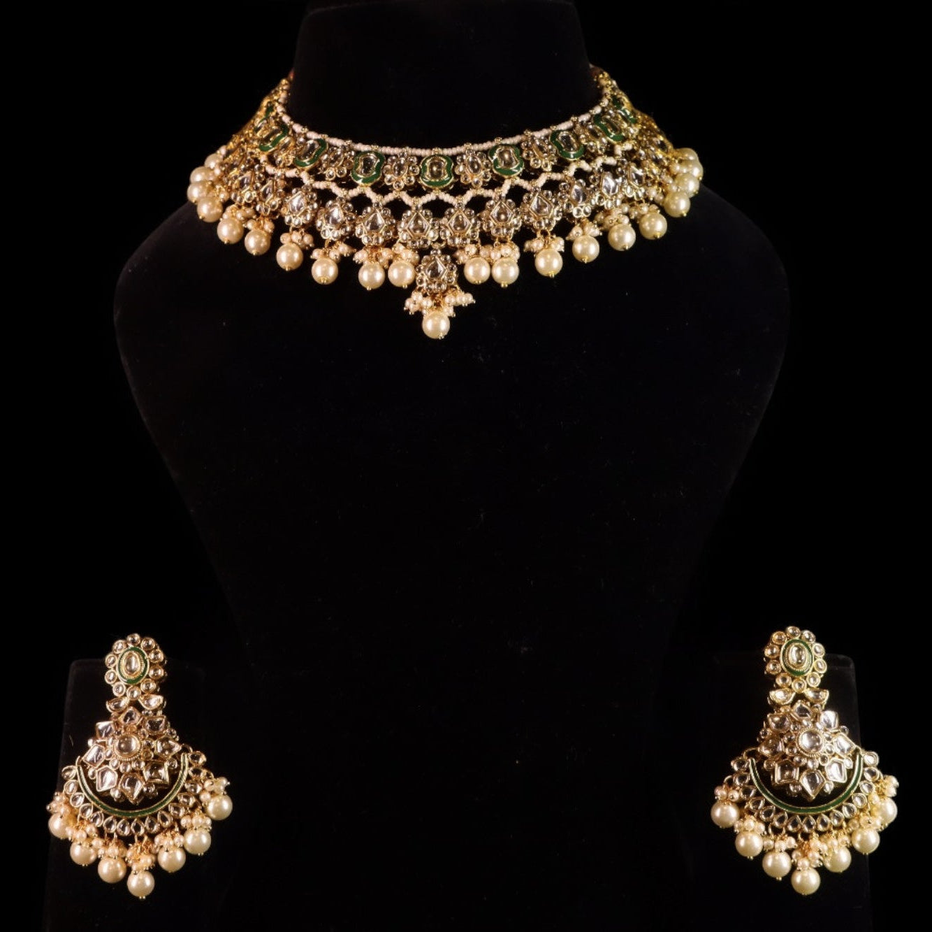 traditional golden kundan set with dangling pearls and green embellishments