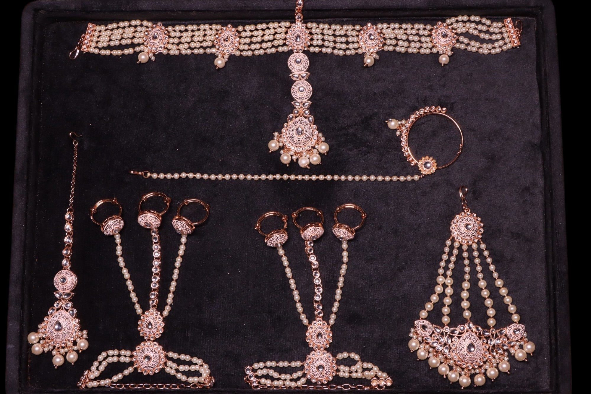 this set includes neckpiece, long haar, earrings, tikka, mattha patti, passa, finger rings and nath