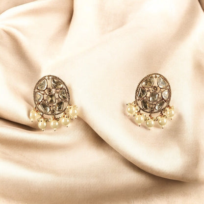 gold toned floral designed kundan earrings with pearls dangling