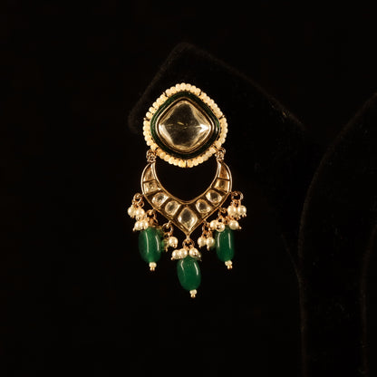 kundan earrings with green emerald stone accents and intricate craftsmanship