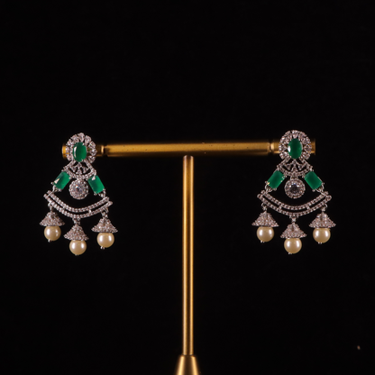A pair of emerald and pearl earrings with diamonds
