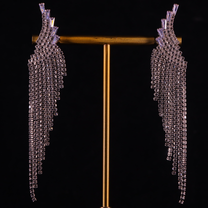 A pair of long, silver, diamond gilded earrings with a crystal design