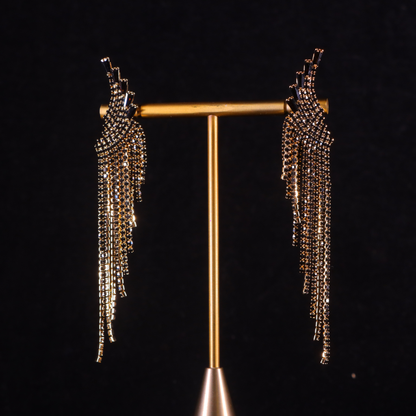 A pair of gilded gold and black party earrings with a tassel design
