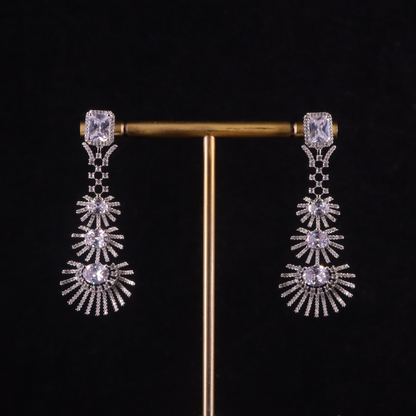 A pair of silver-colored palm leaf-inspired earrings with frosted accents