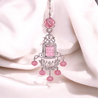 A pink chandelier earring with intricate design